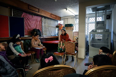 Volunteer Lorraine Lui leads a storytelling session, for visitors at a Spring Fun Festival, where she tells the story of a Hong Kong migrant with puppets she borrowed from her local library. The event...