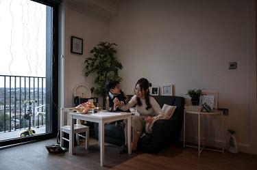Kago Ng, an artist, practices drawing with her son Kasper in their apartment in Sienna House where they are living after moving to the UK on British National Overseas visas. The British government has...