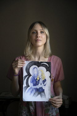 Sonya holds a drawing of her girlfriend, Sasha Skochilenko, made in a pre-trial detention centre.Sasha faces up to 10 years in prison under the laws about 'fakes', for replacing price tags in a superm...