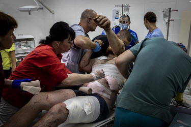 Doctors and nurses, at a hospital in Sloviansk, work to stabilise a Ukrainian soldier, wounded in a leg and his torso by shrapnel from a Russian artillery strike near Izium, before he is transferred t...