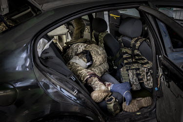 A wounded Ukrainian soldier arrives at a hospital in Sloviansk in the back of a car. His fellow soldiers described how he was shot in the leg and shin, just 40 minutes earlier, by Russian troops who h...
