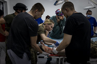 Medics at a hospital in Sloviansk, bandage the shin of a wounded soldier who had been shot by Russian troops less than an hour earlier.