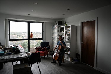 Professional cellist David Wong practices Bach suites in his Sienna House apartment where he now lives after moving to the UK on a British National Overseas visa. Mr Wong played his cello in 'Umbrella...