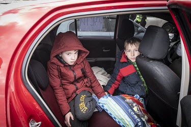 Roma and Valera, refugees from Mauriupol, arrive at a makeshift reception centre in a Zaporizhzhia supermarket car park.