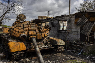 A destroyed Russian tank in the drive way of a burned out house in the village of Velyka Dymerka. The area was heavily fought over and Russian forces occupied the area for nearly a month as they stage...