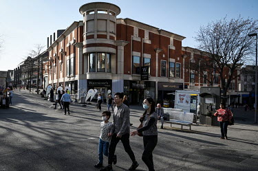People walk along Sutton High Street where a large number of Hong Kong families have settled after moving to the UK on British National Overseas visas. The British government has so far issued approxi...