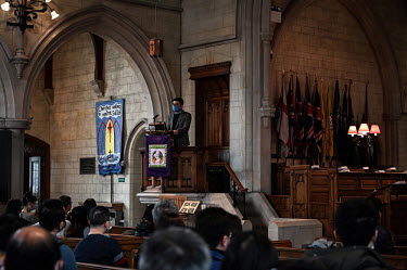 A minister from Hong Kong reads a sermon at Trinity Church, during a service for the growing Hong Kong community living in Sutton. The British government has so far issued approximately 100,000 of the...