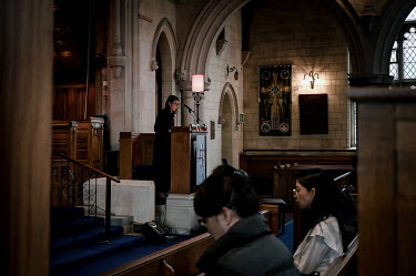 Reverend Kan Yu, a Methodist minister from Hong Kong who has lived in the United Kingdom for twenty years, leads a service at Trinity Church for the growing Hong Kong community living in Sutton. The B...