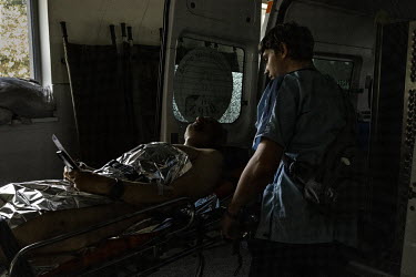 Lieutenant Oleksandr Kolesnikov, who was injured while on the frontline near Slovyansk the previous day, is wheeled into an ambulance before being transferred to another hospital further west.