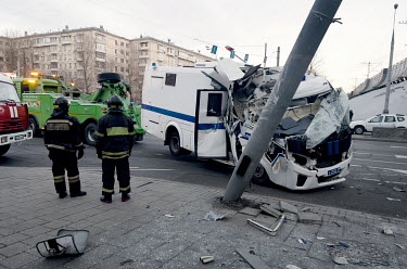 A badly damaged police security vehicle, carrying 27 people arrested for protesting the Russian invasion of Ukraine, which hit a lamp post injuring 11 of those onboard.