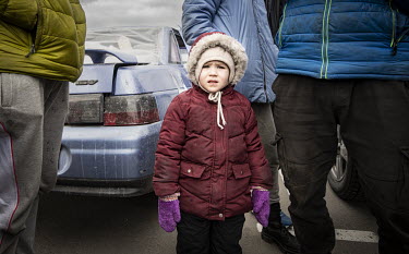 Miana, a refugee from Mauriupol, arrives at a makeshift reception centre in a Zaporizhzhia supermarket car park.