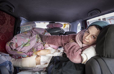 Svitlana, who was injured by shellfire while walking her dog and has had part of her foot amputated, arrives in a vehicle that brought her and companions from Mauriupol to Zaporizhzhia.