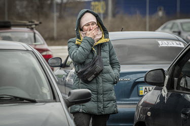 Olga, a refugee from Mauriupol, arrives at a makeshift reception centre in a Zaporizhzhia supermarket car park.