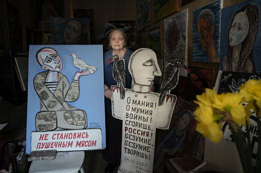 Artist Elena Osipova with her painted anti-war posters. For over 20 years she has regularly made protests on the streets of Saint-Petersburg.The posters have slogans such as: ''Don't become meat for c...