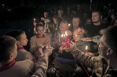 Children from the Yunarmiya movement (Young Army) and family members of military personnel light candles from the Easter Fire during the celebration of Easter in the main temple of the Russian Armed F...