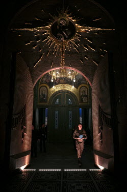 A young military man leaves the temple of the Russian armed forces after an Easter service.