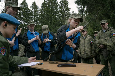 Students of various military-patriotic clubs compete in a time trial disassembling and reassembling a Kalashnikov assault rifle during the 'Zornitsa game'.