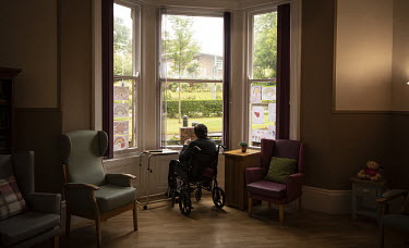 A resident looks out of a window at St Cecilia's Nursing Home where socially distanced visits have started for the first time since it closed its doors to visitors on 11 March 2020.