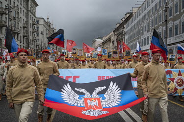Yunarmiya (young army) members carry the flag of Donbass, the banner 'Donbass - Russia' and photographs of participants of the armed conflict in Donbass. They integrate in the procession 'Immortal Reg...
