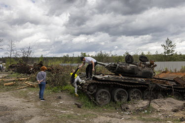 People, many who have just recently returned to the Kyiv region, now visit this graveyard of Russian tanks and armoured vehicles outside the village of Dmytrivka, to have a look and take pictures.