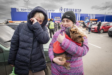 Olga Olanava (45) and Pashkova (25) with dog Sonya, refugees from Mauriupol, at a makeshift reception centre in a Zaporizhzhia supermarket car park.