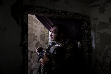 A soldier with the 93rd Mechanised Brigade of Ukraine's Ground Forces, sheltering in an underground bunker at a frontline position in the Kharkiv region.