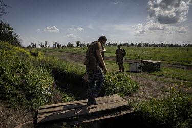 Ukrainian soldiers walk back to their positions in a frontline area near the city of Donetsk.