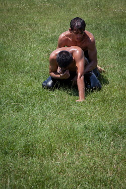 Young oil wrestlers compete during a competition in Silivri. The goal is to get your competitor flat onto the floor and remove a tag from their trousers.