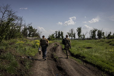 Ukrainian soldiers walk back to their positions in a frontline area near the city of Donetsk.