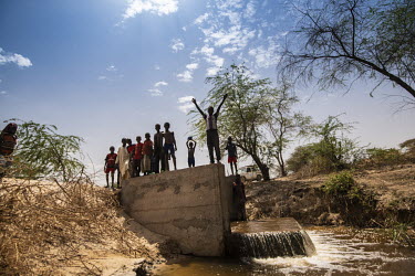 Boys playing beside an UN funded irrigation scheme that manages the water in Lake Chad.  Lake Chad, which spanned 9,652sqm in 1963, has shrunk by 90 per cent in recent decades. Climate change is to bl...