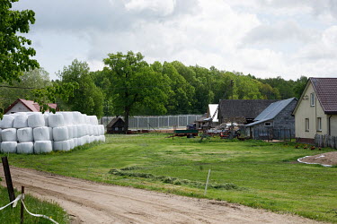 Houses and farm buildings beside the new border fence built between Poland and Belarus.  In the autumn of 2021 there were clashes between Polish police and migrants trying to cross the Polish border w...