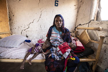 Rasha holds her severely malnourished children, Ibrahim Baniker, who weighs 6kg at 2 years (L), and 3 month old Fatna who weighs 5kg, at the Medair clinic.  Since the end of 2013, conflict has cost al...