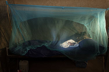 Three day old baby Juma lies on a bed beneath a mosquito net at the Medair clinic. He weighs 1.6 kg and is kept in isolation to prevent him picking up infections from other patients.  Since the end of...