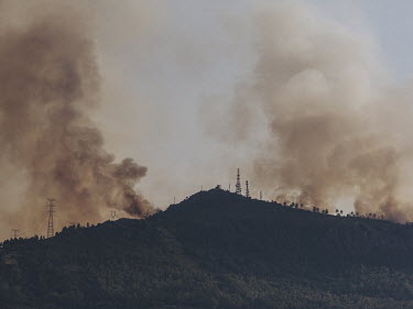 Smoke billows from the Casas de Miravete wildfire. The fire started on the 15 July 2022, threatening the Monfrague National Park and causing local villages to be evacuated. On the 16 July 2022, the fi...