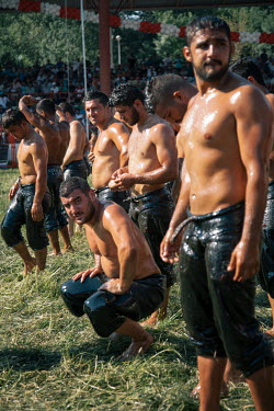 Oil Wrestlers warm up and apply oil to their bodies prior to competing at the Kirkpinar Final. Thousands of fans come to spectate annually despite the sport not being widely known across Turkey itself...