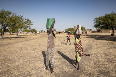 Girls carrrying water containers back to their village after collecting it from the Nile River. Dirty water is the primary cause of disease.  Since the end of 2013, conflict has cost almost 400,000 li...