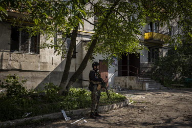 A member of the Ukrainian regional police force patrols in the city of Lysychansk.