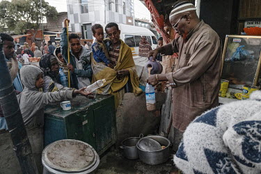 A drinks shop owner gives out free tea to refugees who have crossed th eborder from Ethiopia. Restaurant and tea shop owners feel obliged to help out with the situation.