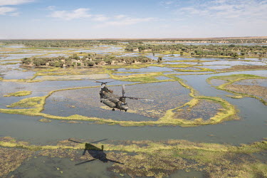 An RAF Chinook helicopter flies over flooded land as part of Operation NEWCOMBE CH47, the codename for British military assistance to France's Operation Barkhane. NEWCOMBE consists of three Royal Air...