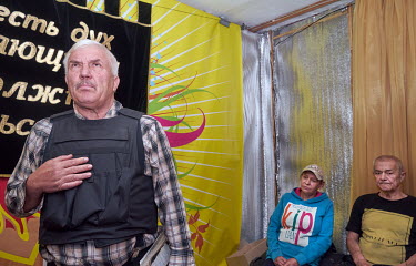 Priest Leonid of the Christian Church of the Awakening giving a mass service at the Rubin Theatre. After the service people will receive a package of food. The population of Avdiivka before Russia's i...