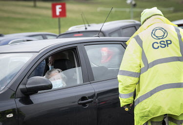 Odette Dobson (86) waits for her vaccination in the car park at the mass vaccination centre established at Epsom Racecourse.