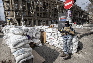 A Ukrainian fighter takes a break at his post in downtown Odesa.