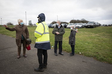 Confused patients ask for information at the mass COVID-19 vaccination centre established at Epsom Racecourse.