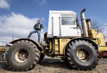 Vasyl Rozymyak, chief engineer at the UKRGRAIN farm, stands on a tractor at the facility in the Odessa Oblast.  Ukraine produces almost 12% of the wheat in the global export market.