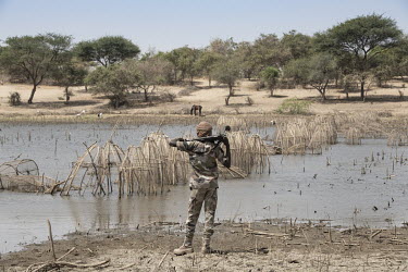 A member of the Chadian defence forces looks over a part of Lake Chad where fishing has become almost unsustainable, on the look-out for the ever-present Boko Haram.   Lake Chad, which spanned 9,652sq...