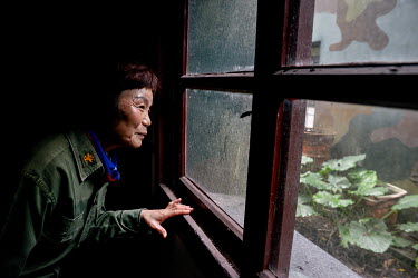 Former military radio broadcaster, Ms. Chao Rui-fang, dressed in her original uniform during a visit to the broadcasting studio she once worked from, on a now disused army base. Over a long career, sp...