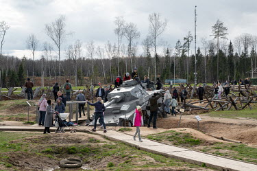 People climb on a Nazi tank at Park Patriot in Moscow.