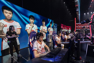 Two teams of professional gamers compete in an E-game arena during a match.
