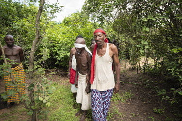 Witch doctors Yembe (R), whose real name is Kazungu Karisa, conducts a ritual cleansing to allow an accused witch to be reintegrated into their community.  Kaya Godhoma, a refuge built on holy ground...