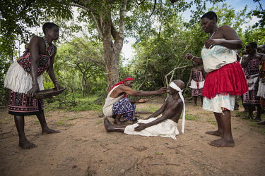 Witch doctors Yembe (red bandana), whose real name is Kazungu Karisa, conducts a ritual cleansing to allow an accused witch to be reintegrated into their community.  Kaya Godhoma, a refuge built on ho...